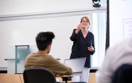 Christina Paxson in front of a classroom. 