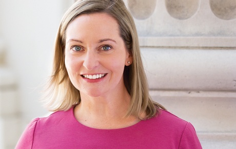 Photograph of Parker Hamilton Poling &rsquo;99 standing beside a marble column