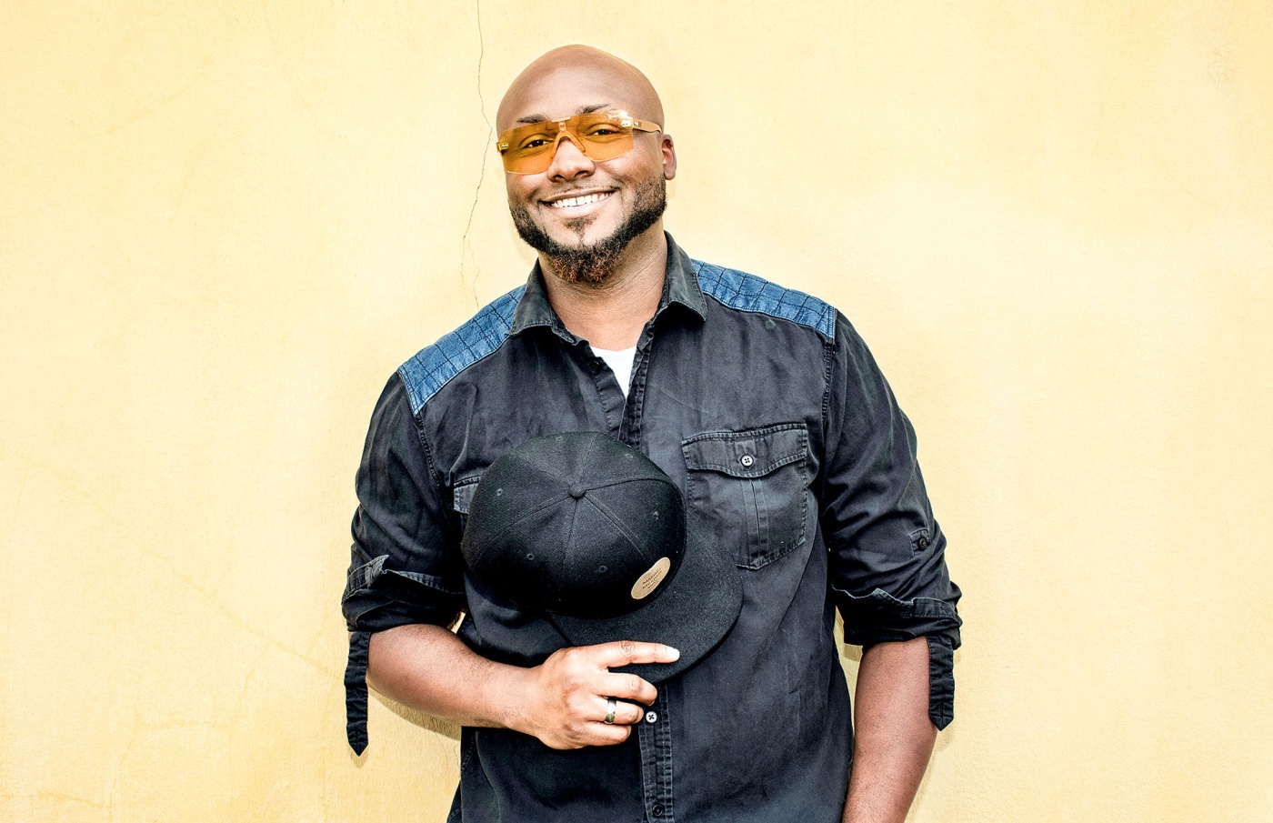 Image of a smiling Granger Simmons with a yellow background.