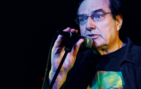 Close-up image of Steve Morse speaking into a microphone.