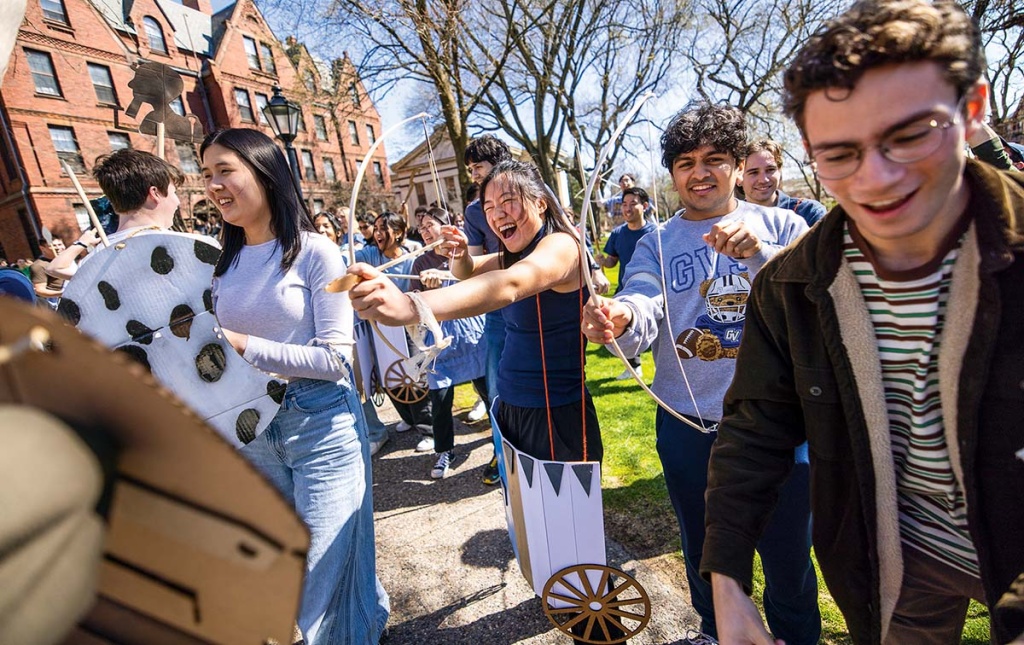 An image of students on the green with bows and arrows and dressed like ancient Egyptians