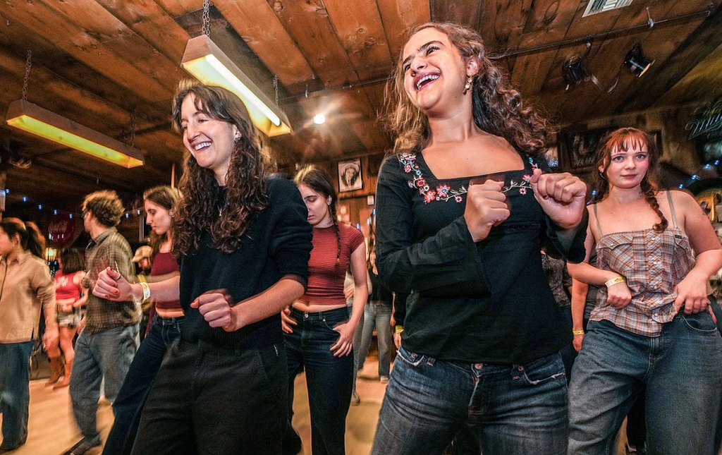 Image of students line dancing in a barn