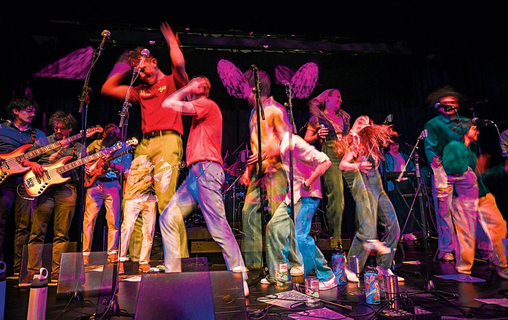 Super-imposed image of the band the Stowaways on stage.