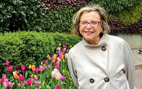 Image of Phyllis Beck standing in front of tulips.
